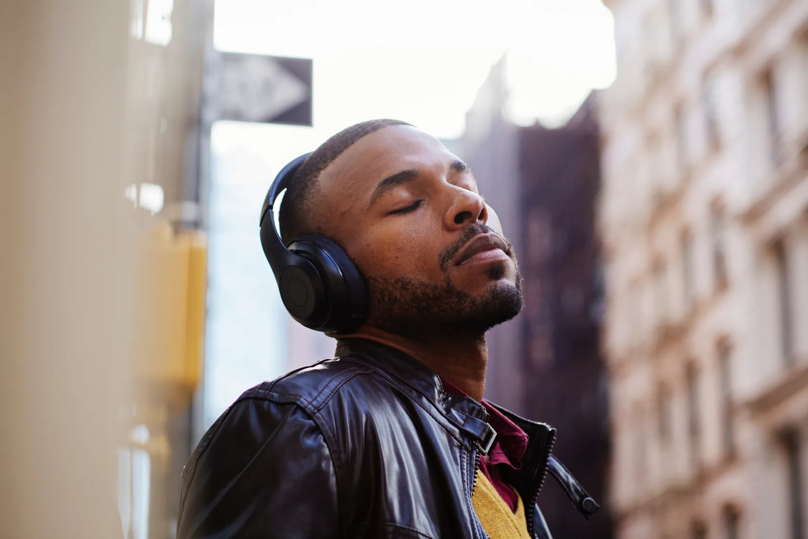 A creator with headphones reviewing work on a phone